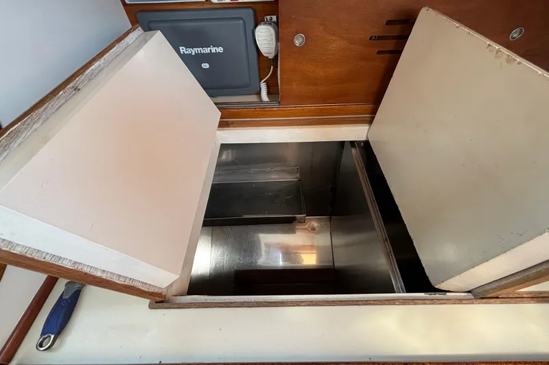 Slide: The Image of Interior view of a 1974 Hinckley Bermuda 40 MKIII sailboat with open storage compartment. - 36