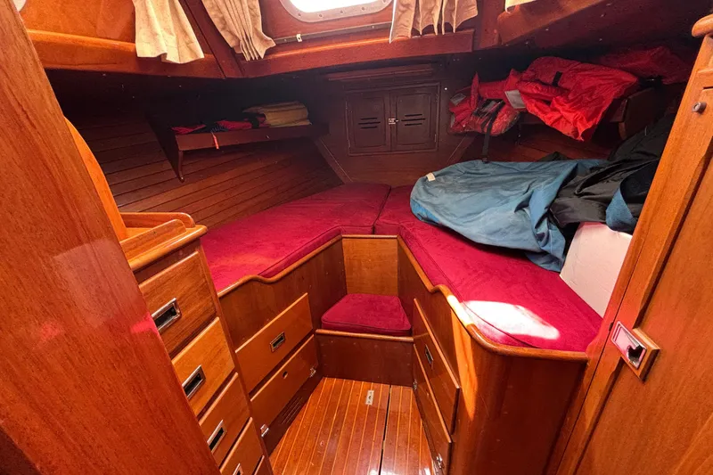 Slide: The Image of 1974 Hinckley Bermuda 40 MKIII cabin with wooden interior and red cushions. - 37