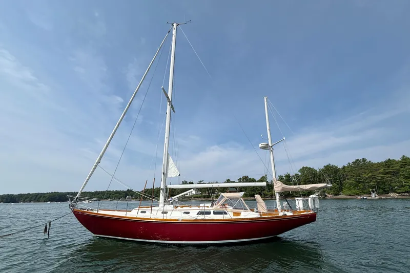 Slide: The Image of 1974 Hinckley Bermuda 40 MKIII sailboat on calm water under clear sky. - 4