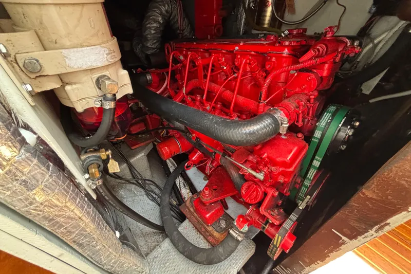 Slide: The Image of Engine compartment of a 1974 Hinckley Bermuda 40 MKIII sailboat, featuring a red engine. - 47