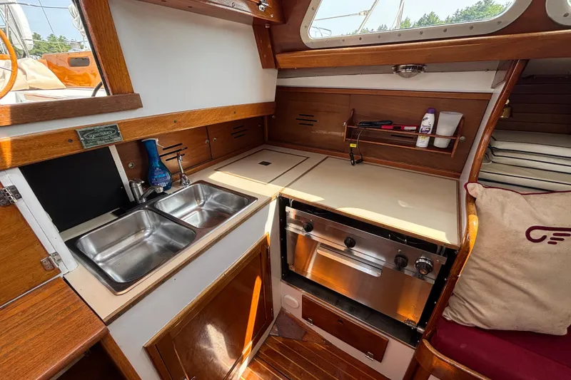 Slide: The Image of 1974 Hinckley Bermuda 40 MKIII yacht kitchen with dual sinks and stove. - 31