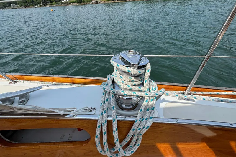 Slide: The Image of 1974 Hinckley Bermuda 40 MKIII sailboat deck with winch and coiled rope. - 23