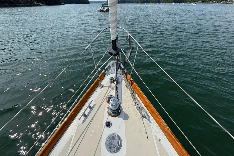 Slide: The Image of Bow view of 1974 Hinckley Bermuda 40 MKIII sailboat on calm water. - 8