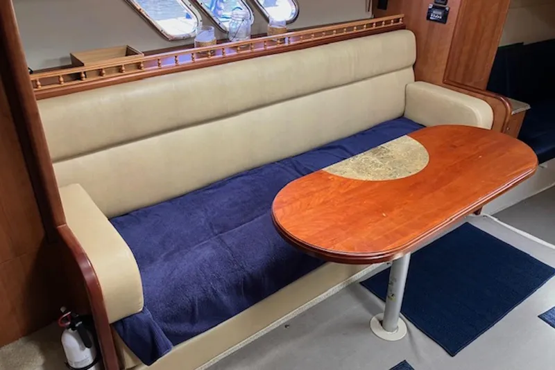 Slide: The Image of 2009 Cruisers Yachts 360 Express interior with beige seating and wooden table. - 34