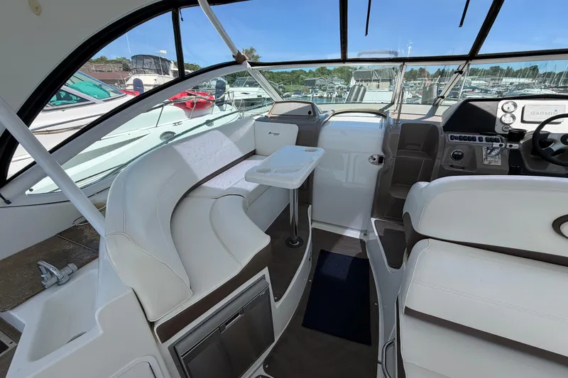Slide: The Image of Interior of 2009 Cruisers Yachts 360 Express with white seating and helm controls. - 25