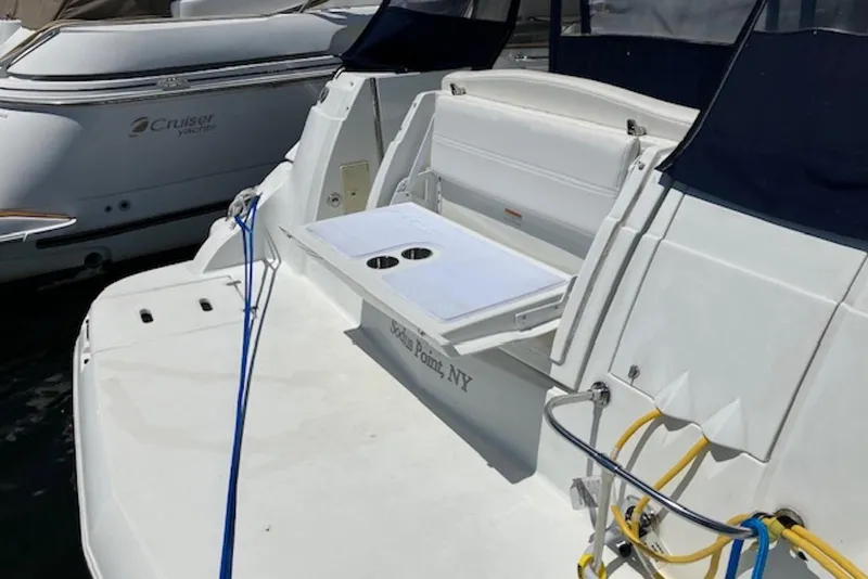 Slide: The Image of 2009 Cruisers Yachts 360 Express docked, featuring a swim platform and seating area. - 13