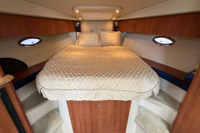 Slide: The Image of Luxurious cabin interior of 2009 Cruisers Yachts 360 Express with cozy bed and wooden accents. - 44