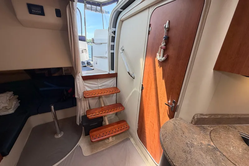 Slide: The Image of Interior of 2009 Cruisers Yachts 360 Express with wooden steps and nautical decor. - 31