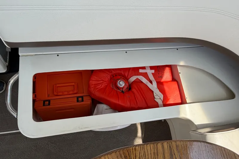 Slide: The Image of Storage compartment on 2009 Cruisers Yachts 360 Express with safety equipment and orange case. - 55