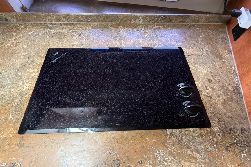 Slide: The Image of Black stovetop on marble countertop in 2009 Cruisers Yachts 360 Express. - 41