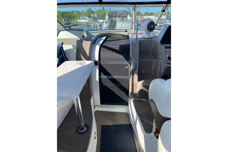 Slide: The Image of 2009 Cruisers Yachts 360 Express interior with helm, seating, and table. - 30