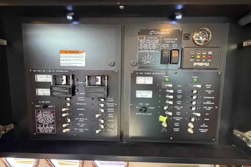 Slide: The Image of Electrical control panel of 2009 Cruisers Yachts 360 Express, featuring power distribution switches. - 63