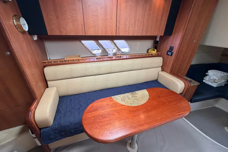 Slide: The Image of 2009 Cruisers Yachts 360 Express interior with wooden table and cushioned seating. - 35