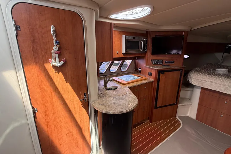 Slide: The Image of Interior of 2009 Cruisers Yachts 360 Express with kitchenette and cozy sleeping area. - 36