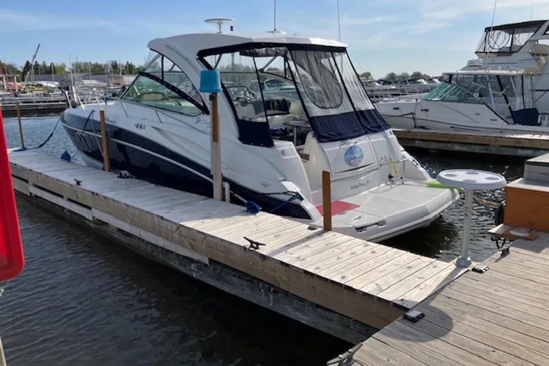 Slide: The Image of 2009 Cruisers Yachts 360 Express docked at a marina, showcasing sleek design and luxury features. - 2