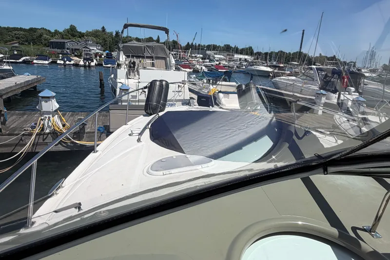 Slide: The Image of 2009 Cruisers Yachts 360 Express docked at marina, surrounded by boats. - 7