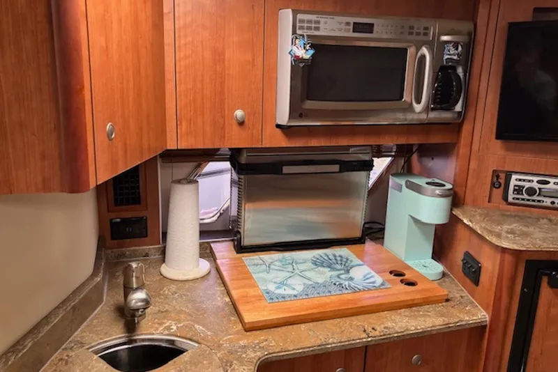 Slide: The Image of 2009 Cruisers Yachts 360 Express kitchen with microwave, sink, and coffee maker. - 39