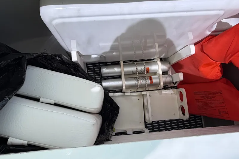 Slide: The Image of Storage compartment in a 2009 Cruisers Yachts 360 Express with safety equipment. - 56
