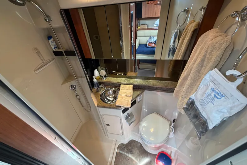 Slide: The Image of Luxurious bathroom in 2009 Cruisers Yachts 360 Express, featuring shower, sink, and toilet. - 49