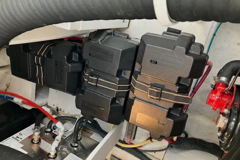 Slide: The Image of Engine compartment of 2009 Cruisers Yachts 360 Express, featuring battery boxes and wiring. - 51