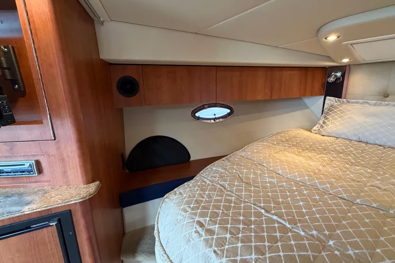 Slide: The Image of 2009 Cruisers Yachts 360 Express cabin interior with bed and wooden cabinetry. - 47