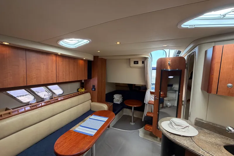 Slide: The Image of Interior of 2009 Cruisers Yachts 360 Express, featuring elegant wood cabinetry and seating. - 32