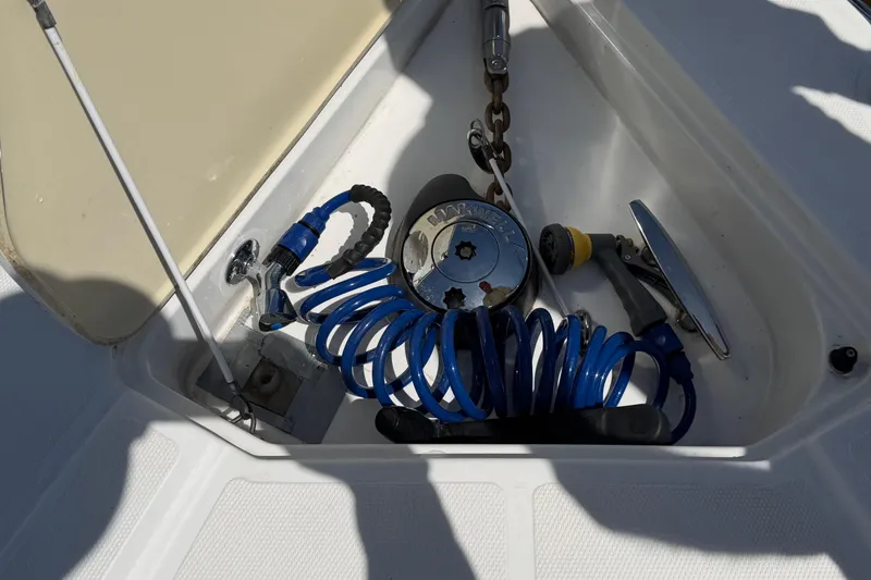 Slide: The Image of Storage compartment on 2009 Cruisers Yachts 360 Express with coiled hose and anchor chain. - 58