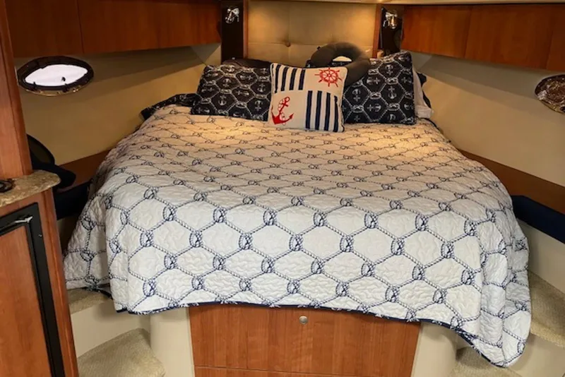Slide: The Image of Cozy cabin interior of 2009 Cruisers Yachts 360 Express with nautical-themed bedding. - 43