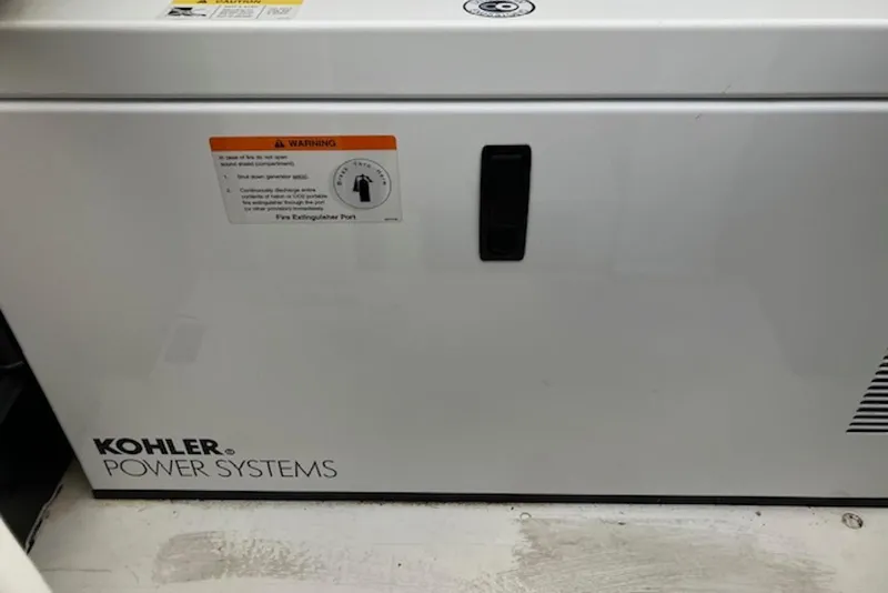 Slide: The Image of Kohler Power Systems generator on 2009 Cruisers Yachts 360 Express, featuring safety warning label. - 53