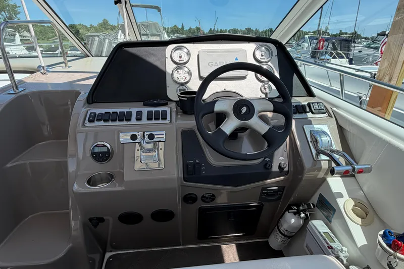 Slide: The Image of 2009 Cruisers Yachts 360 Express helm with steering wheel and control panel. - 28