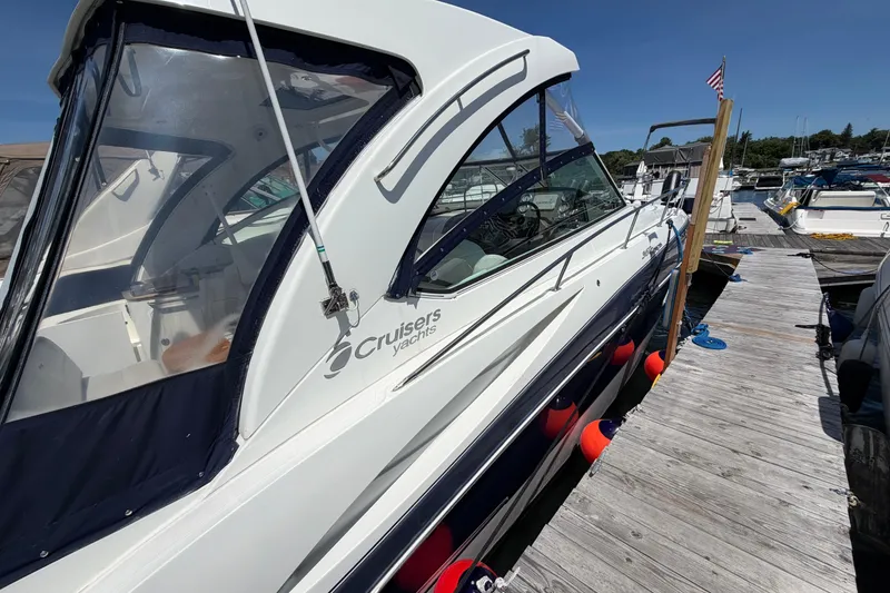 Slide: The Image of 2009 Cruisers Yachts 360 Express docked at marina under clear blue sky. - 4