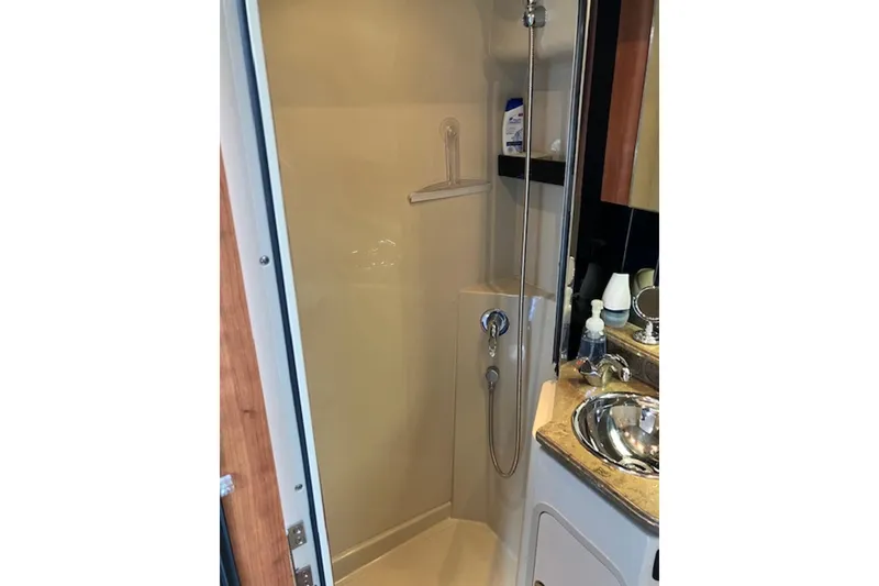 Slide: The Image of 2009 Cruisers Yachts 360 Express bathroom with shower, sink, and modern fixtures. - 48