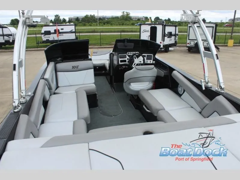 Slide: The Image of The image shows the interior of a 2017 X Series NXT 22 boat with gray seating and a helm. - 11