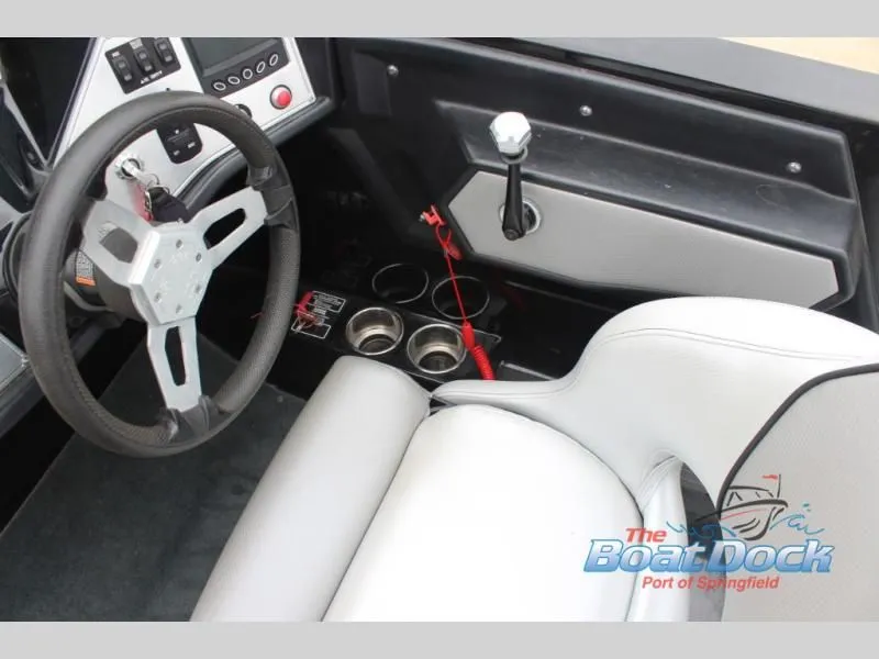 Slide: The Image of Interior view of a boat with a modern steering wheel, gear shift, and cup holders. - 27