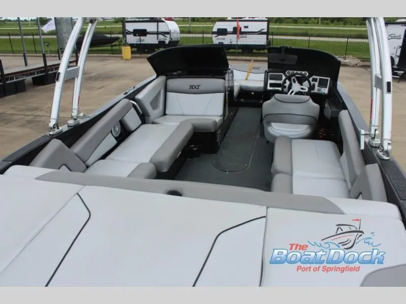 Slide: The Image of The image shows the interior of a 2017 X Series NXT 22 boat with gray upholstery and a modern helm. - 10