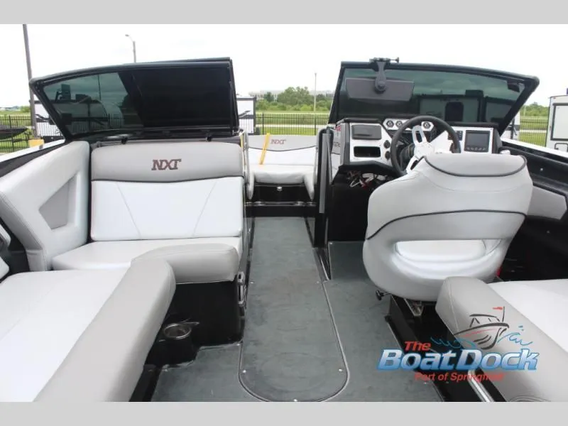Slide: The Image of Interior view of a 2017 X Series NXT 22 with gray and white seating and a modern helm. - 14