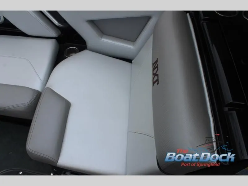 Slide: The Image of Close-up of a boat seat with gray and white upholstery and "NXT" logo. - 30