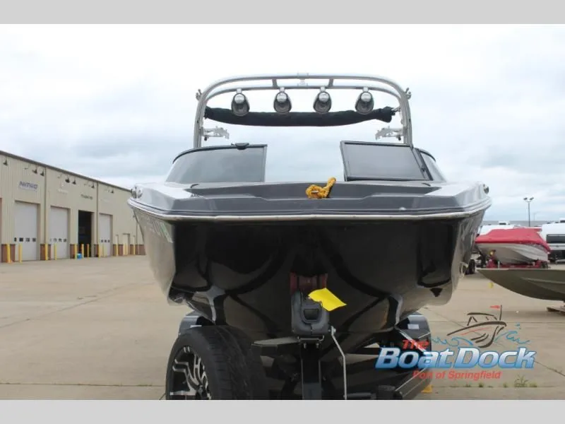 Slide: The Image of A black 2017 X Series NXT 22 boat on a trailer in a storage area. - 3