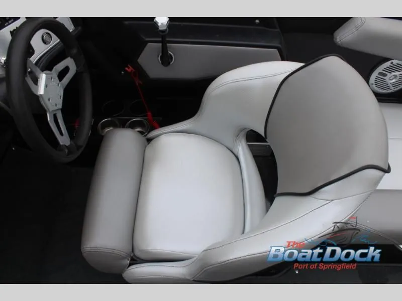 Slide: The Image of The interior of a boat featuring a gray and white seat and a steering wheel. - 28
