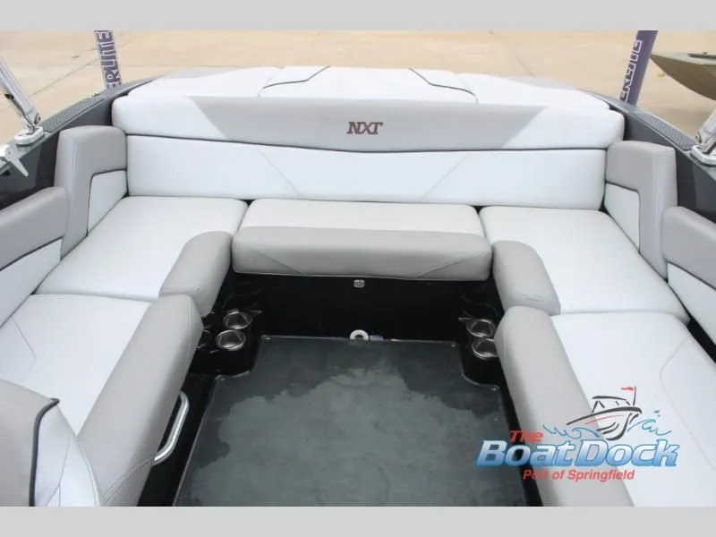 Slide: The Image of Interior view of a 2017 X Series NXT 22 with gray and white upholstery and cup holders. - 17