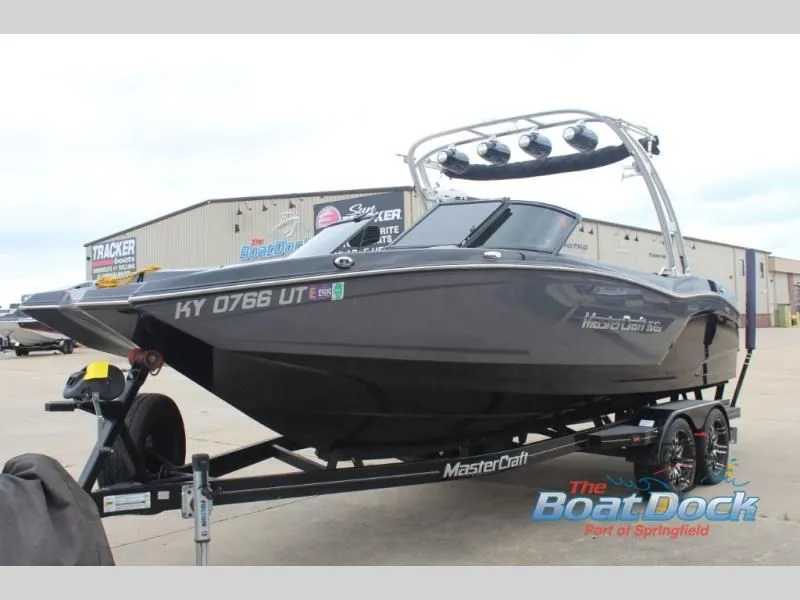 Slide: The Image of A gray motorboat, 2017 X Series NXT 22 model, sits on a trailer at a dock. - 4