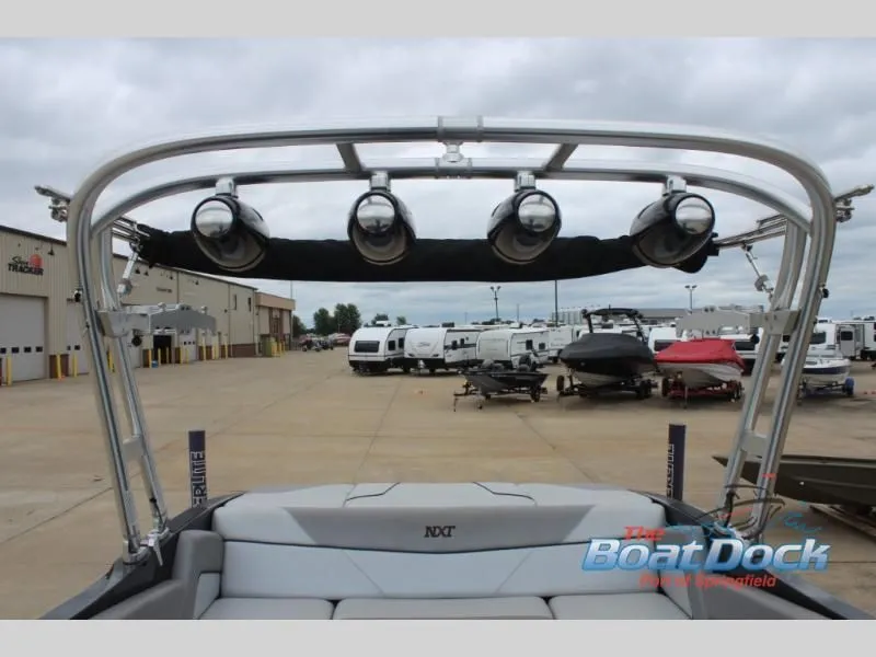 Slide: The Image of The image shows a 2017 X Series NXT 22 boat with a sturdy wakeboard tower and speakers. - 19