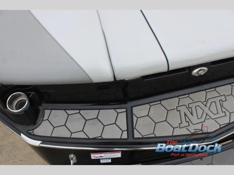 Slide: The Image of Close-up of the stern of a 2017 X Series NXT 22 boat with honeycomb pattern and logo. - 12