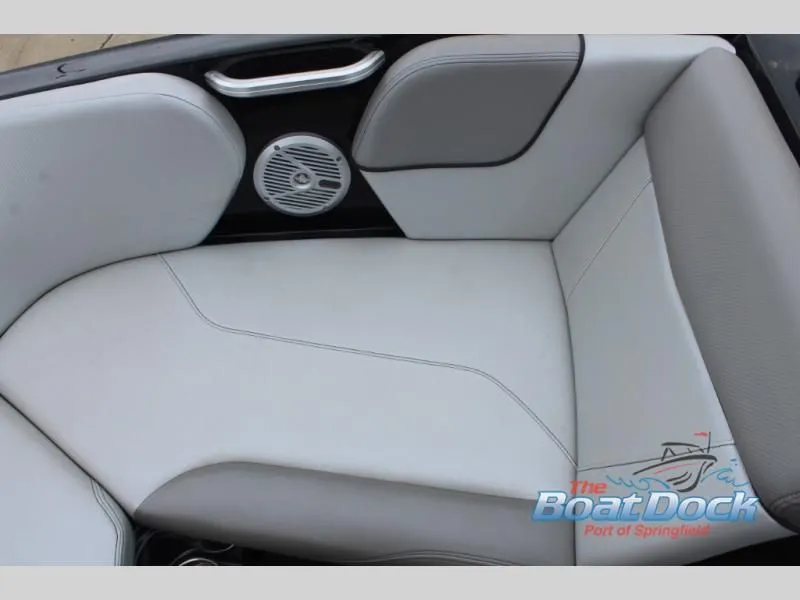 Slide: The Image of The image shows a cushioned seat with gray and white leather upholstery and a built-in speaker. - 34
