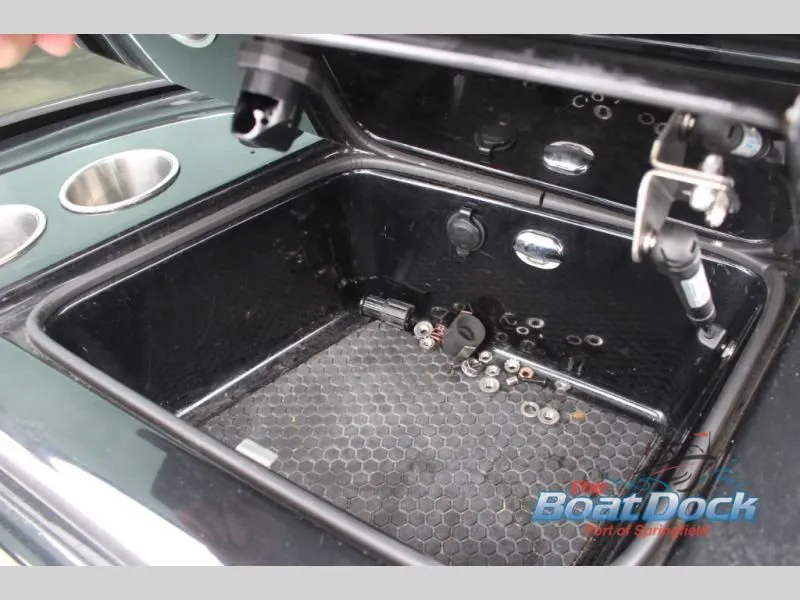 Slide: The Image of An open storage compartment on a boat with some small items inside. - 31