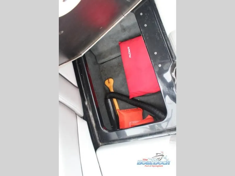 Slide: The Image of An open storage compartment with tools and accessories inside. - 21