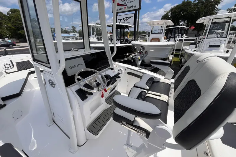 Slide: The Image of 2026 Tidewater 210 CC Adventure boat interior with Garmin system and comfortable seating. - 13