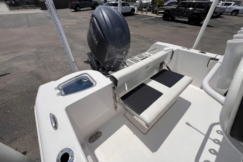 Slide: The Image of 2026 Tidewater 210 CC Adventure boat with Yamaha outboard motor, featuring a sleek rear seating area. - 6