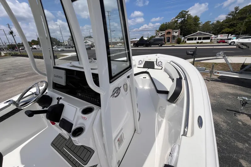 Slide: The Image of 2026 Tidewater 210 CC Adventure boat interior with Garmin navigation system, sleek design, and spacious seating. - 9