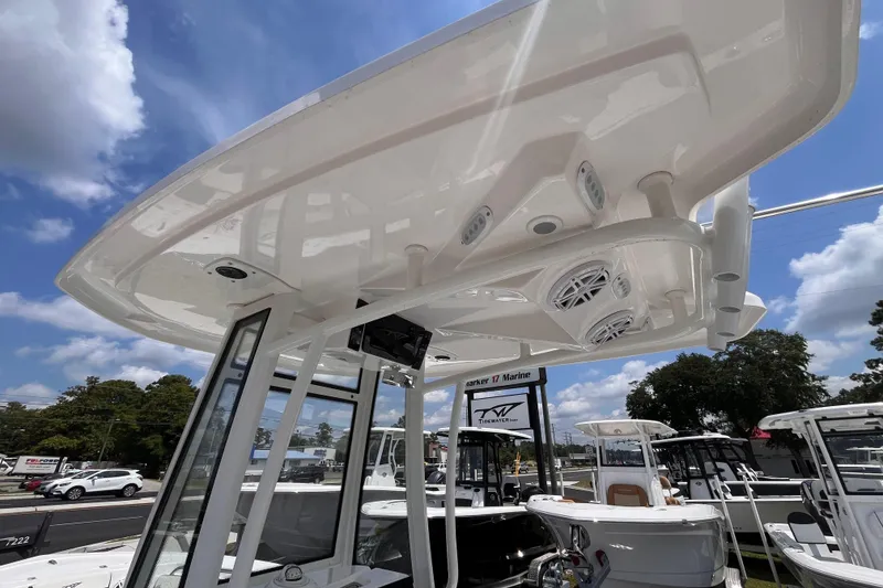Slide: The Image of 2026 Tidewater 210 CC Adventure boat with T-top and speakers, displayed outdoors. - 15